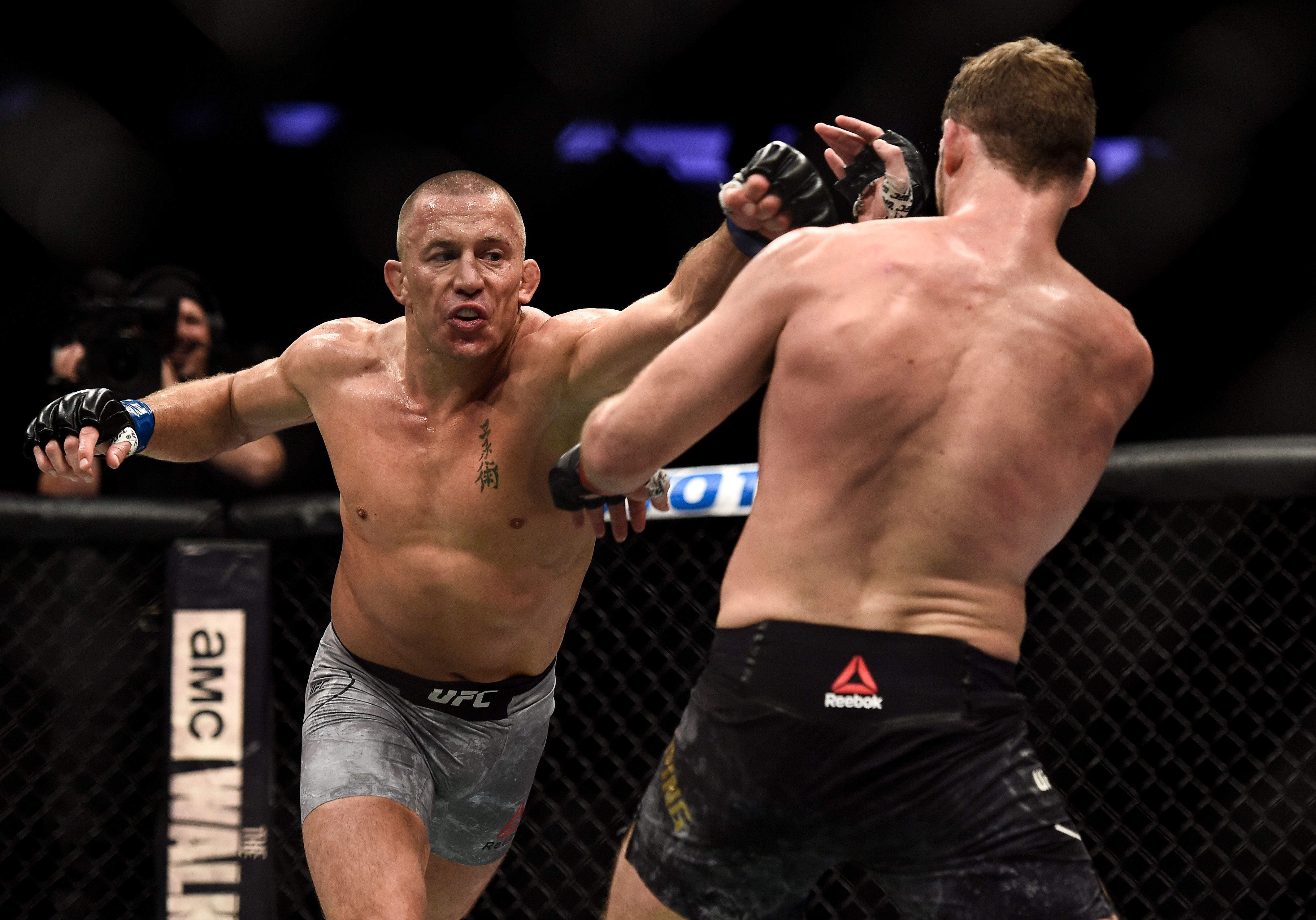 NEW YORK, NY - NOVEMBER 04:  (L-R) Georges St-Pierre of Canada punches Michael Bisping of England in their UFC middleweight championship bout during the UFC 217 event inside Madison Square Garden on November 4, 2017 in New York City. (Photo by Brandon Magnus/Zuffa LLC/Zuffa LLC via Getty Images)