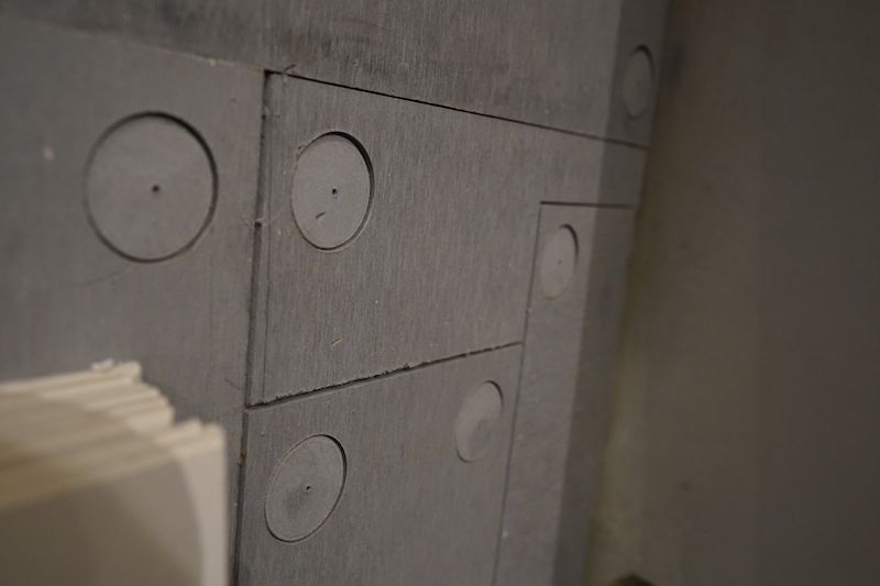 ▲原與設計公司約定用清水模牆面，最後卻用矽酸鈣板挖4個洞並隨意亂拼貼，畸形難看。