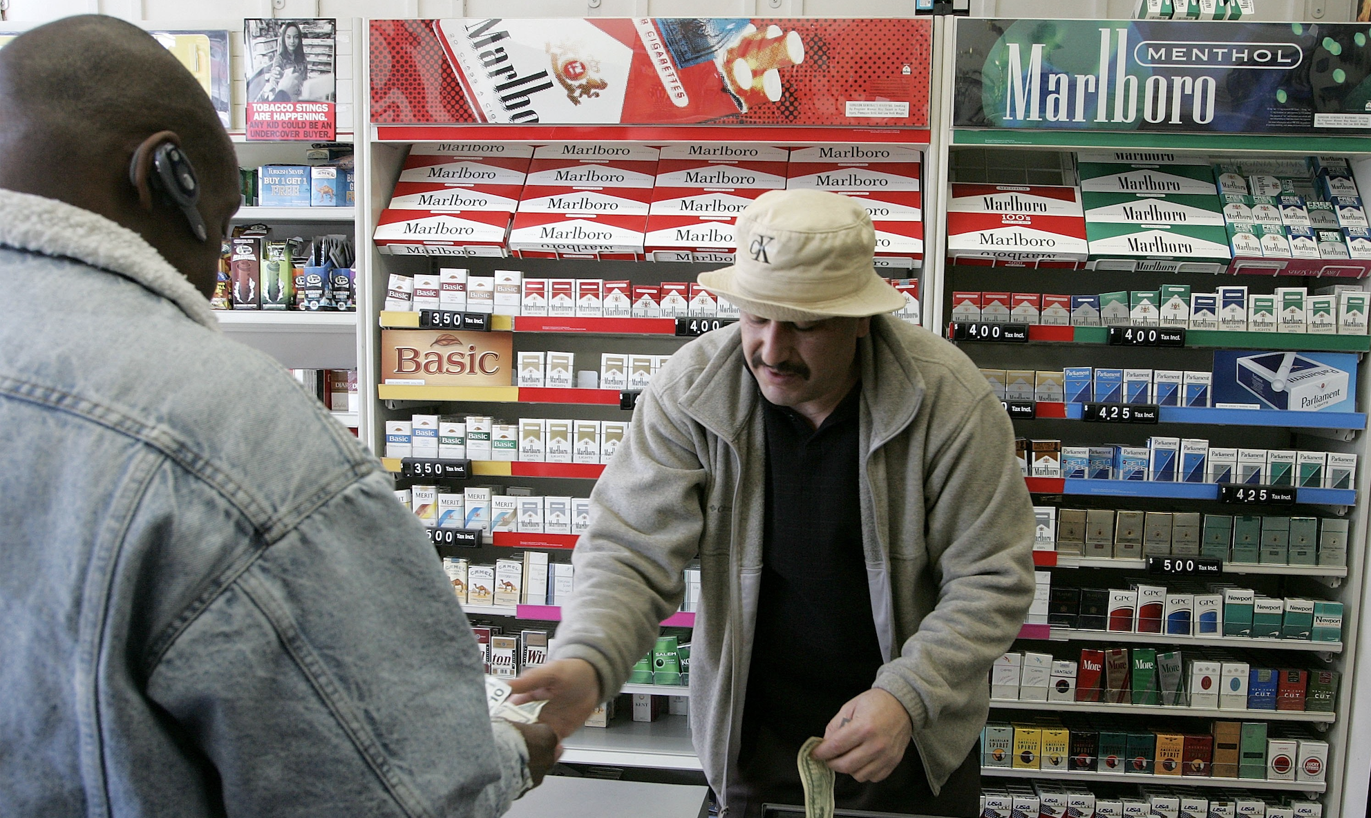 Shop owner Izzat Asfour sells a pack of cigarettes to a customer March 9, 2006 in San Francisco. (Photo: Justin Sullivan/Getty Images)