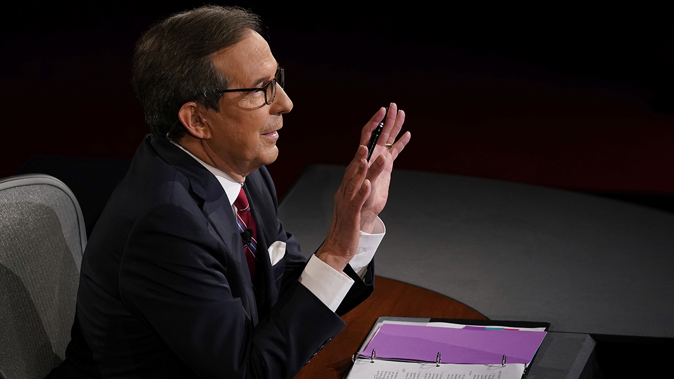 Moderator Chris Wallace of Fox News gestures toward President Donald Trump and Democratic presidential candidate former Vice President Joe Biden during the first presidential debate Tuesday, Sept. 29, 2020, at Case Western University and Cleveland Clinic, in Cleveland, Ohio. (Morry Gash, Pool via AP)