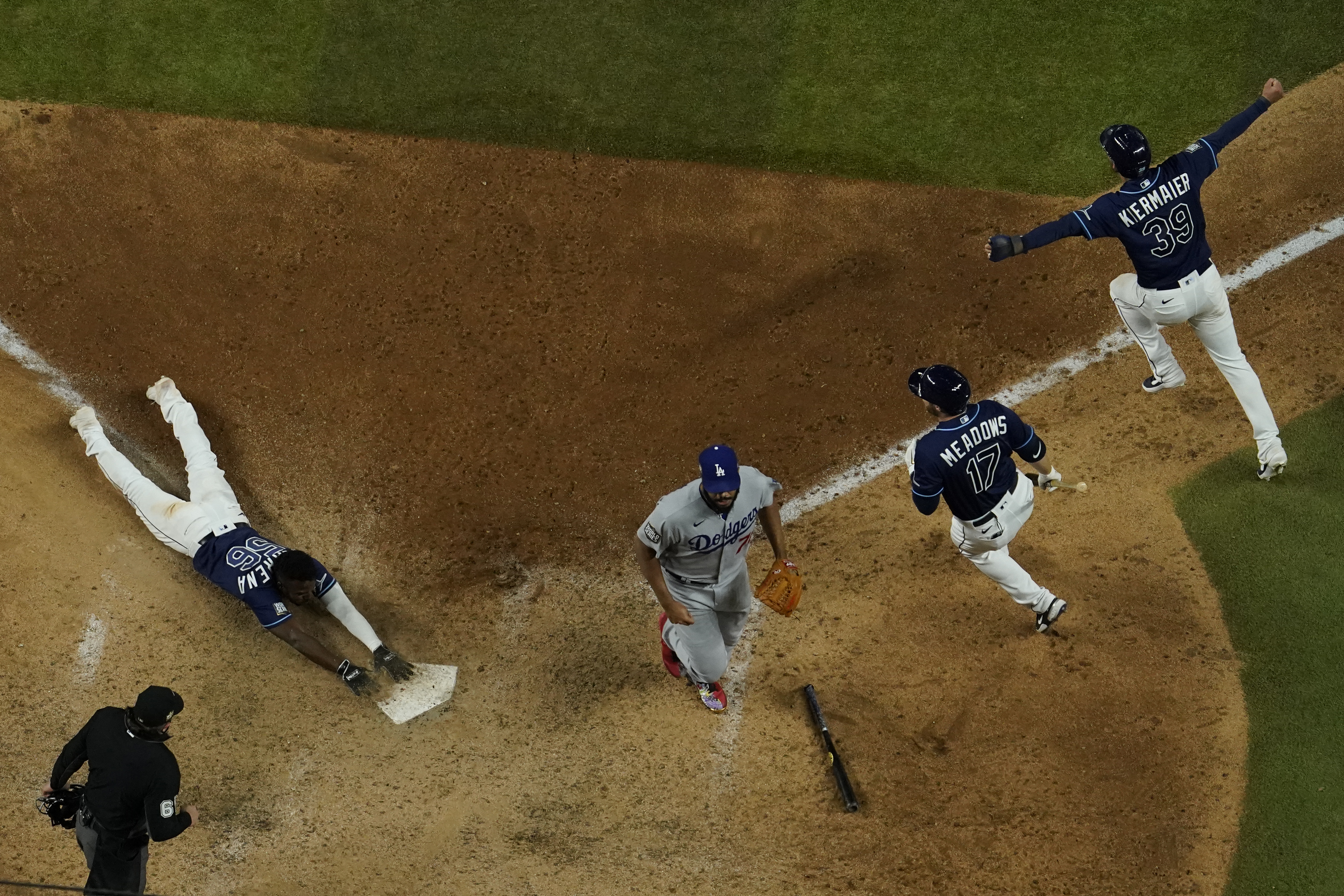 Tampa Bay Rays' Randy Arozarena touches after scoring the winning run against the Los Angeles Dodgers in Game 4 of the baseball World Series Saturday, Oct. 24, 2020, in Arlington, Texas. Rays defeated the Dodgers 8-7 to tie the series 2-2 games. (AP Photo/David J. Phillip)