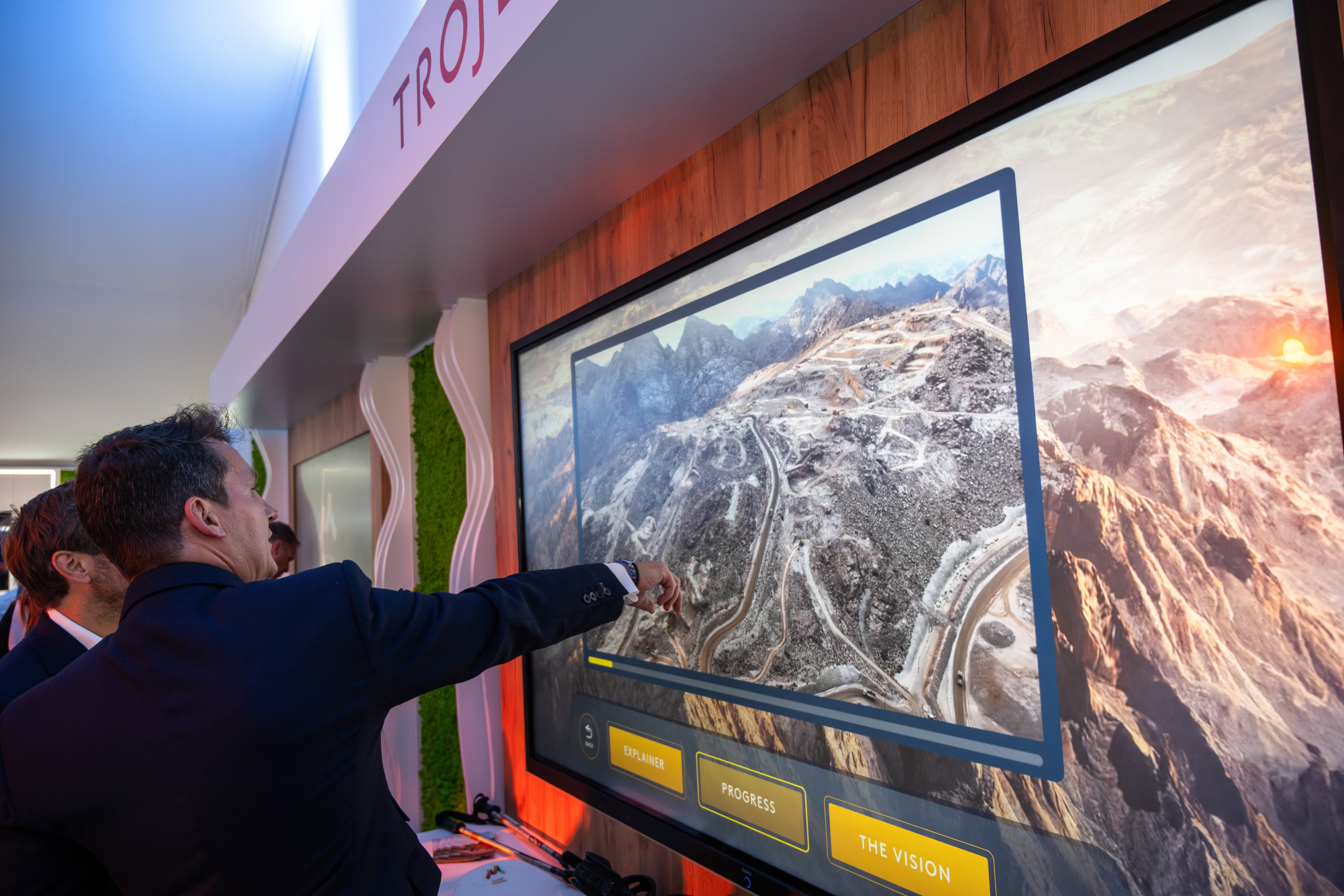 CANNES, FRANCE - 2024/03/13: Businessmen watch an on-screen presentation of Saudi Arabia's Trojena project at the MIPIM in Cannes. The MIPIM Fair in Cannes, southern France, is considered to be one of the world's largest real estate exhibitions. The event highlights real estate from around the globe and pledges "to be a pioneering event in matters of sustainability". More than 22,000 delegates are expected to attend from 90 countries. (Photo by Laurent Coust/SOPA Images/LightRocket via Getty Images)