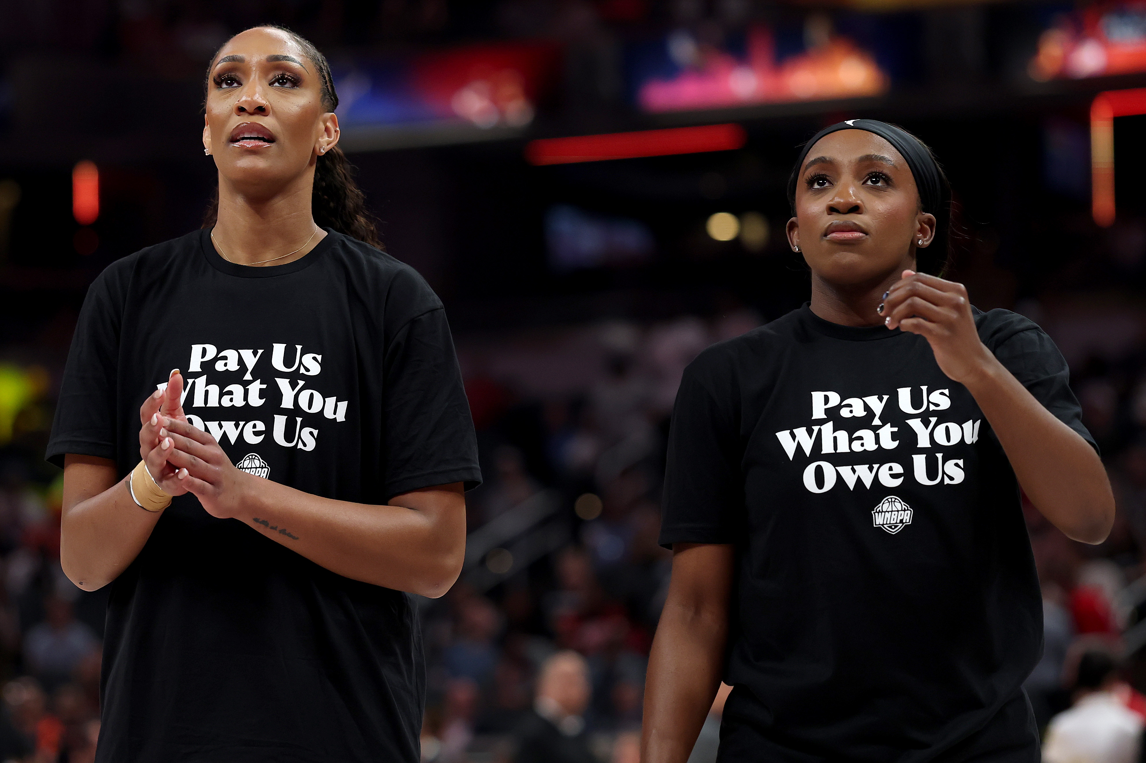 INDIANAPOLIS, INDIANA - JULY 19:  A’ja Wilson #22 of the Las Vegas Aces and Jackie Young #0 of the Las Vegas Aces wear shirts saying "Pay us what you owe us" prior to the 2025 AT&T WNBA All-Star Game at Gainbridge Fieldhouse on July 19, 2025 in Indianapolis, Indiana. NOTE TO USER: User expressly acknowledges and agrees that, by downloading and or using this photograph, User is consenting to the terms and conditions of the Getty Images License Agreement. (Photo by Steph Chambers/Getty Images)