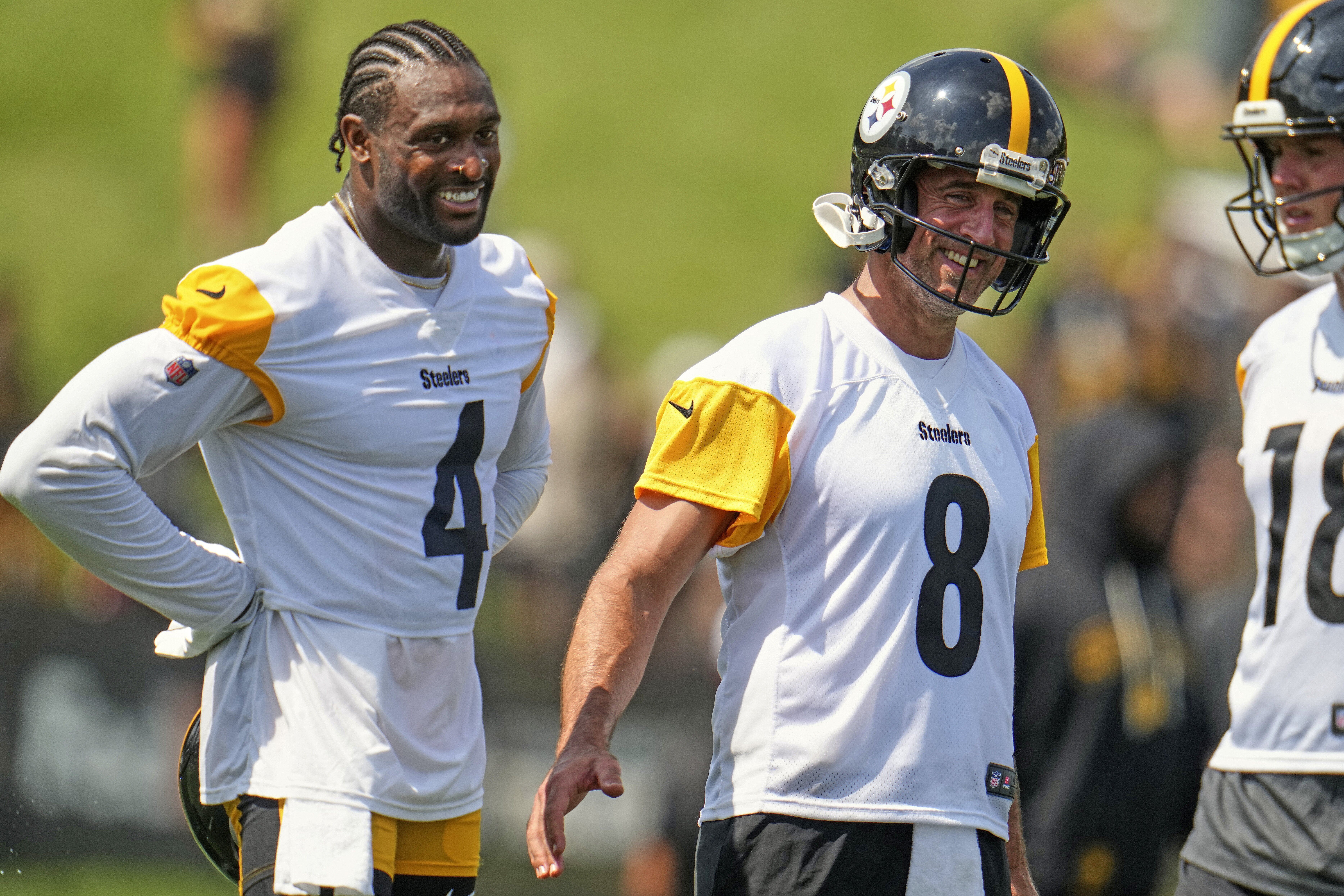 Pittsburgh Steelers quarterback Aaron Rodgers (8) and wide receiver D.K. Metcalf (4) smile during practice at the team's NFL football training camp in Latrobe, Pa., Thursday, July 24, 2025. (AP Photo/Gene J. Puskar)