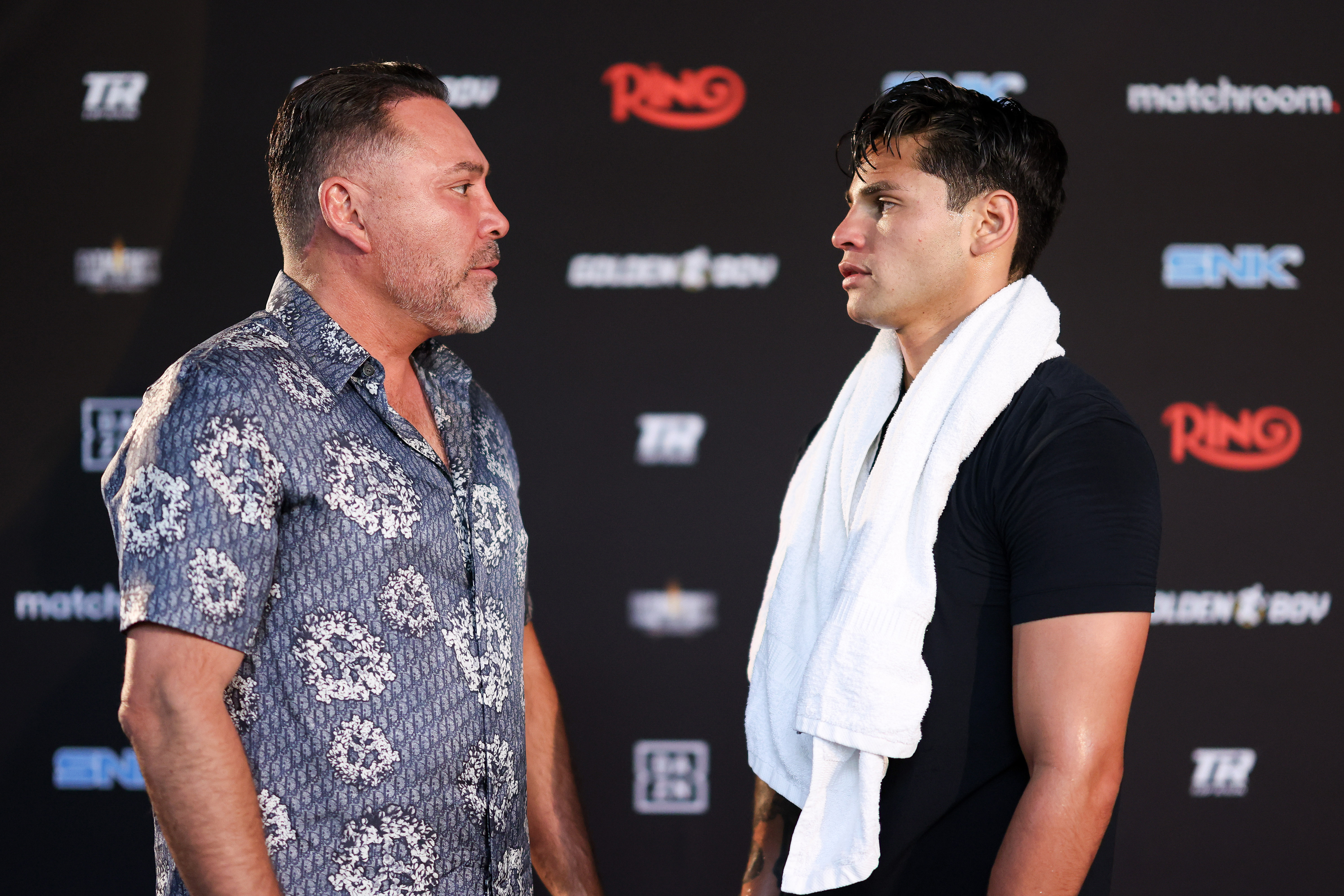 SAN DIEGO, CALIFORNIA - APRIL 17: Boxing promoter Oscar De La Hoya and Ryan Garcia talk during a media workout at The BXNG Club ahead of his WBA regular Welterweight fight against Rolando Romero on April 17, 2025 in San Diego, California. (Photo by Cris Esqueda/Golden Boy/Getty Images)