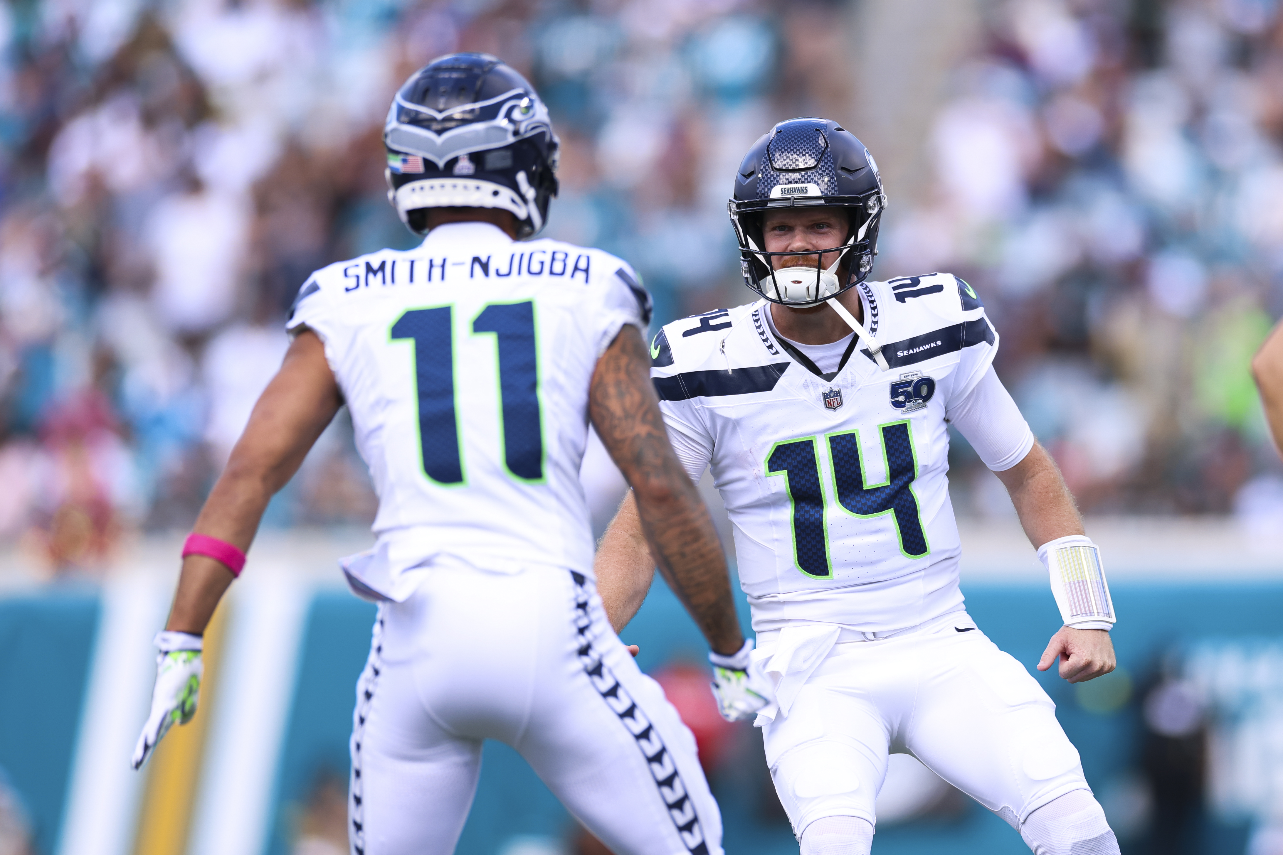 JACKSONVILLE, FLORIDA - OCTOBER 6: Jaxon Smith-Njigba #11 and Sam Darnold #14 of the Seattle Seahawks celebrate a touchdown during the second quarter of the NFL football game against the Jacksonville Jaguars at Everbank Stadium on October 12, 2025 in Jacksonville, Florida. (Photo by Logan Bowles/Getty Images)