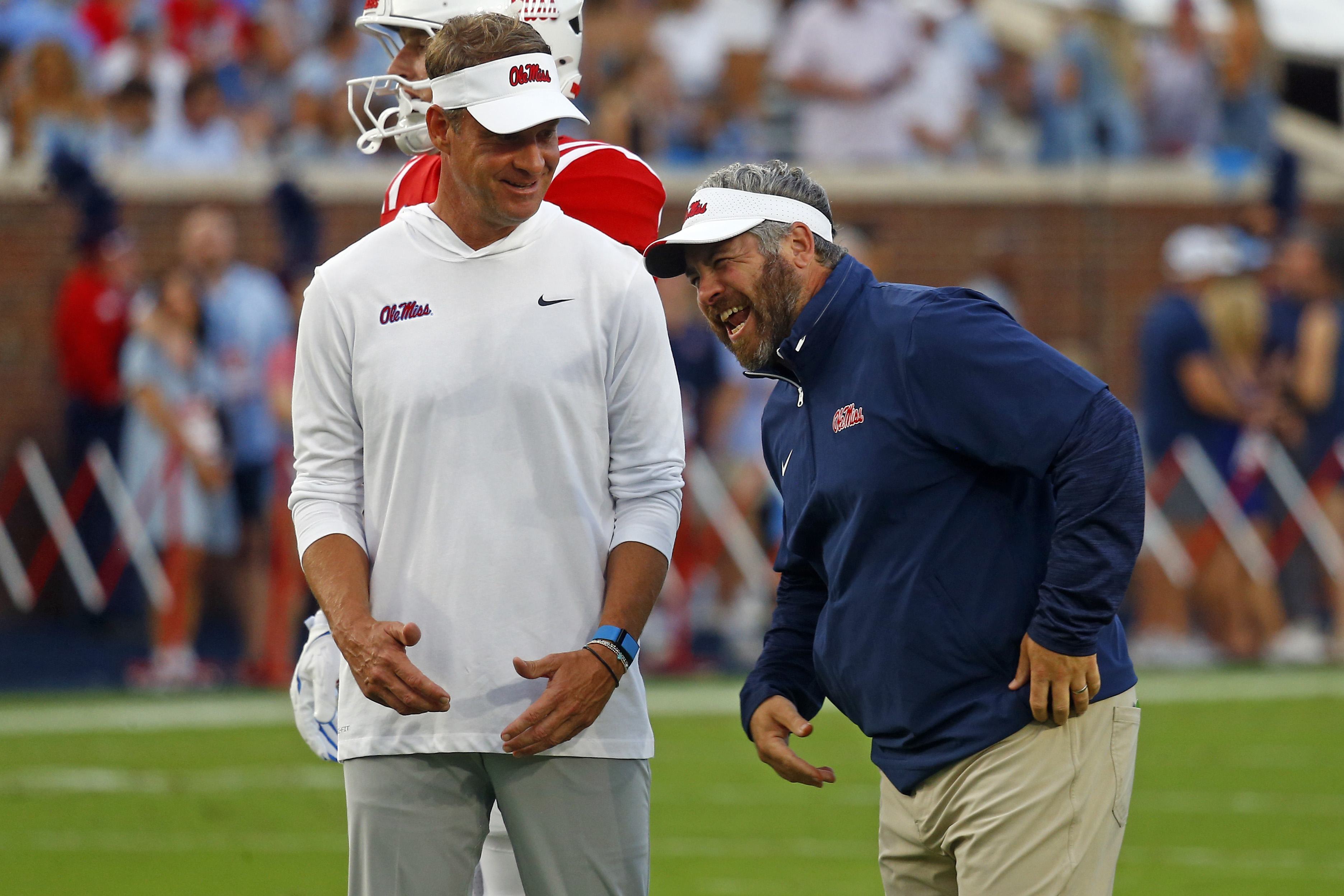 Sep 21, 2024; Oxford, Mississippi, USA; Mississippi Rebels head coach Lane Kiffin (left) shares a laugh with defensive coordinator Pete Golding (right) during warm ups prior to the game against the Georgia Southern Eagles at Vaught-Hemingway Stadium. Mandatory Credit: Petre Thomas-Imagn Images