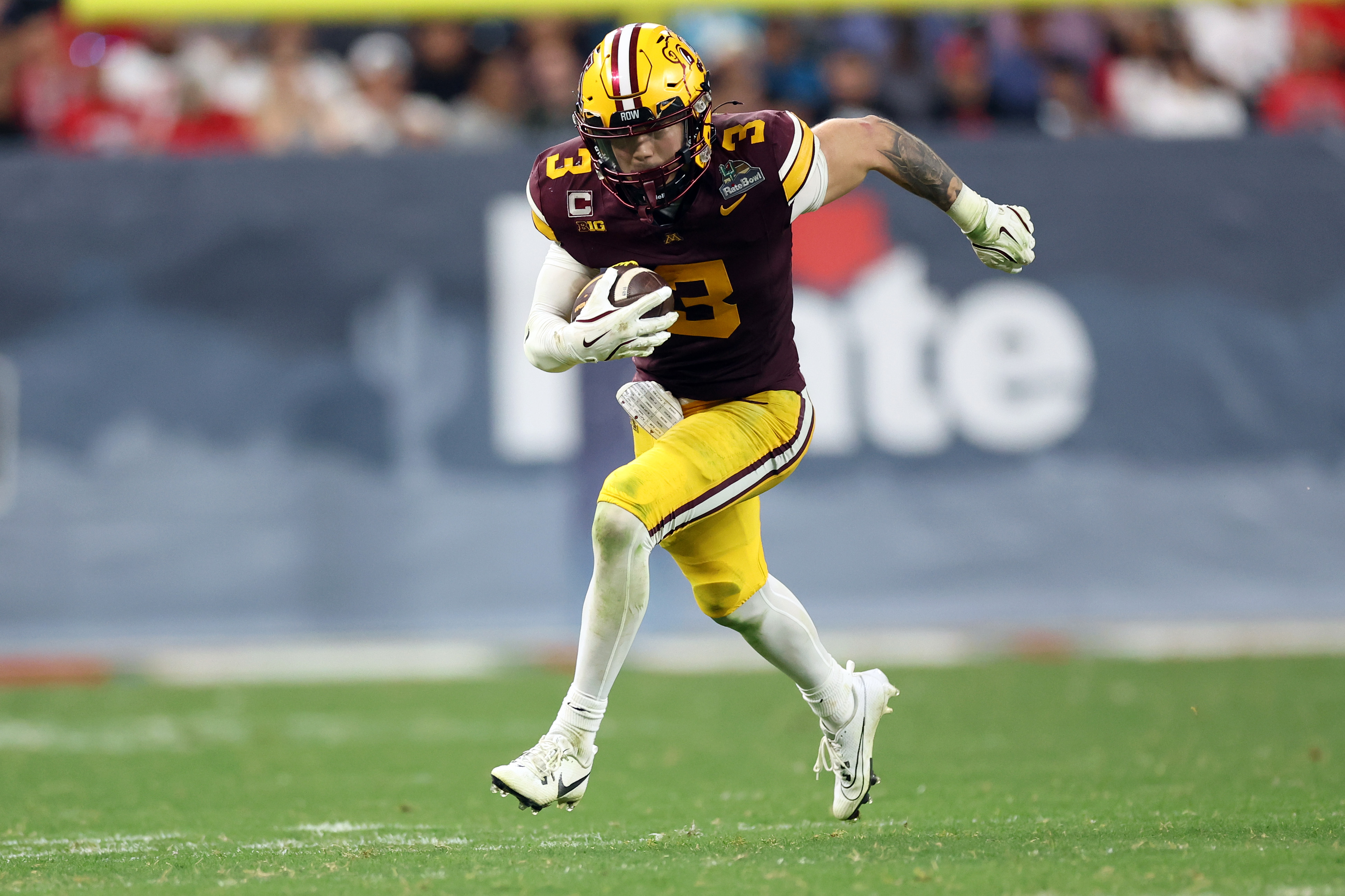PHOENIX, ARIZONA - DECEMBER 26: Koi Perich#3 of the Minnesota Golden Gophers runs the ball during the second half of the 2025 Rate Bowl against the New Mexico Lobos at Chase Field on December 26, 2025 in Phoenix, Arizona. The Golden Gophers defeated the Lobos 20-17 in overtime. (Photo by Chris Coduto/Getty Images)