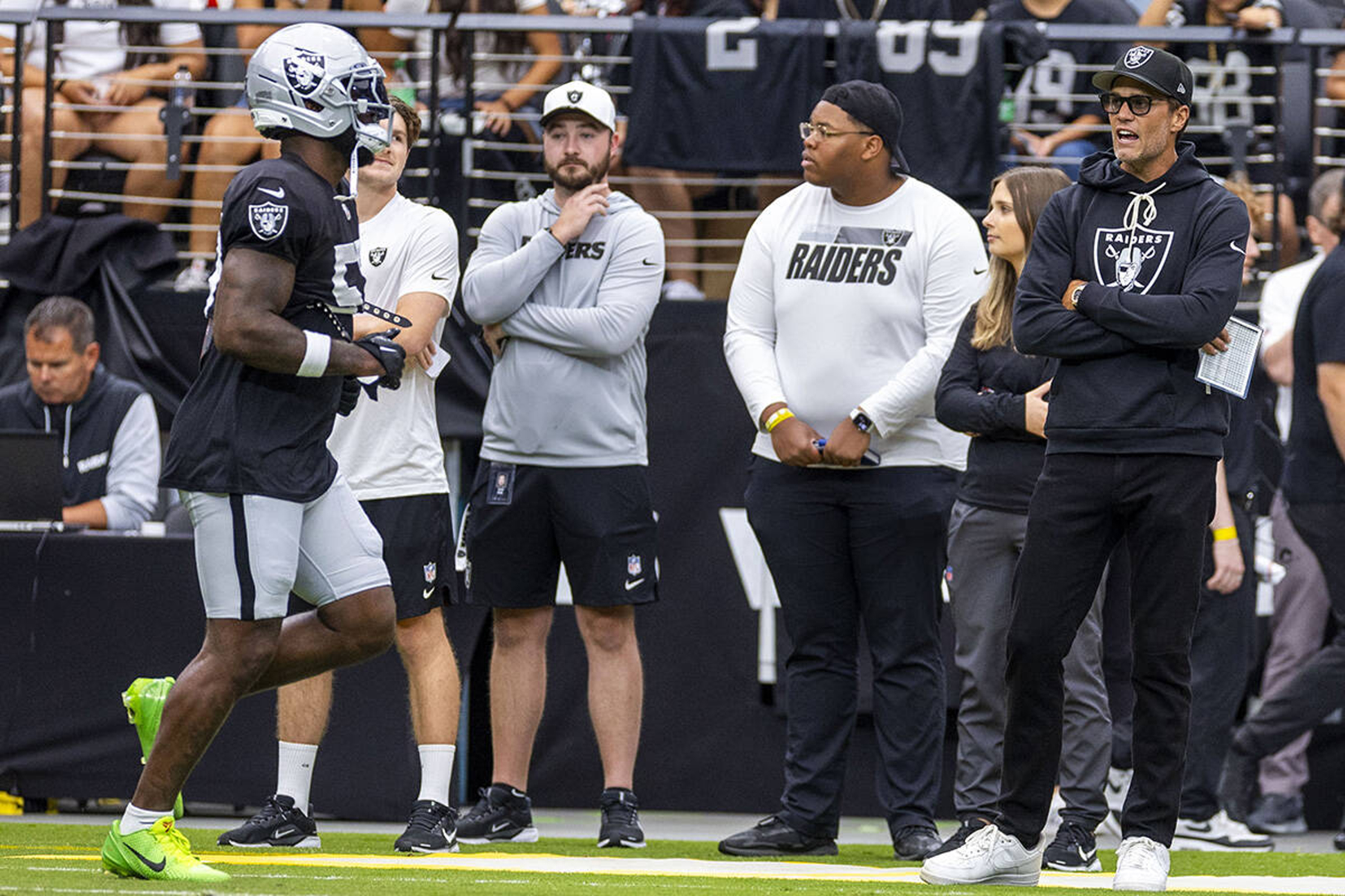 Las Vegas Raiders minority owner Tom Brady, far right, yells encouragement to players as they take the field during the first half of a Raiders training camp mock game at Allegiant Stadium on Saturday, Aug. 2, 2025, in Las Vegas. (L.E. Baskow/Las Vegas Review-Journal/Tribune News Service via Getty Images)