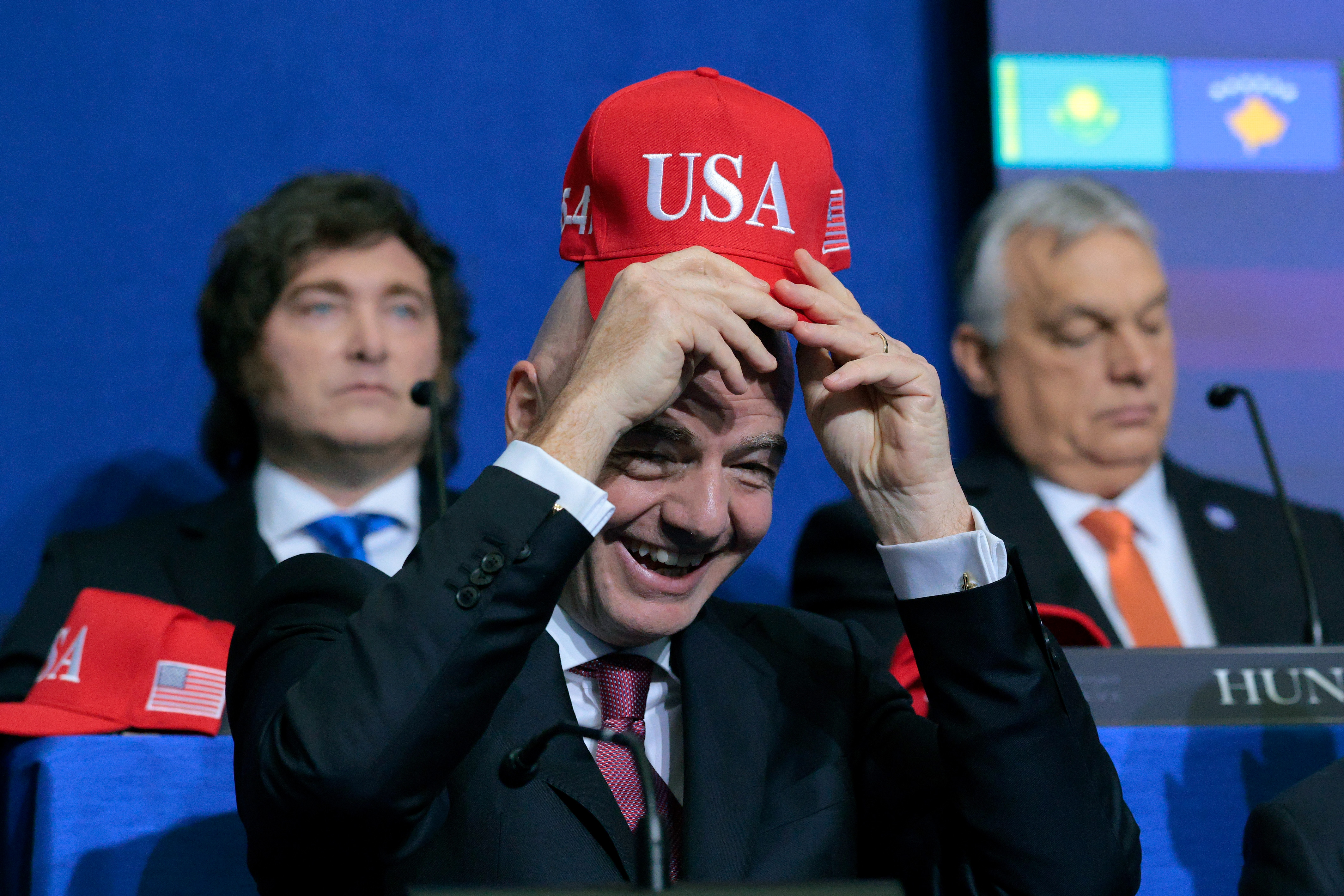 WASHINGTON, DC - FEBRUARY 19:  President of FIFA Gianni Infantino holds up a USA hat as he attends the inaugural meeting of the Board of Peace at the Institute of Peace on February 19, 2026 in Washington, DC. Assembled to raise money for the rebuilding and stabilization of Gaza, Trump's Board of Peace was formally established on the sidelines of World Economic Forum in January of 2026. (Photo by Chip Somodevilla/Getty Images)