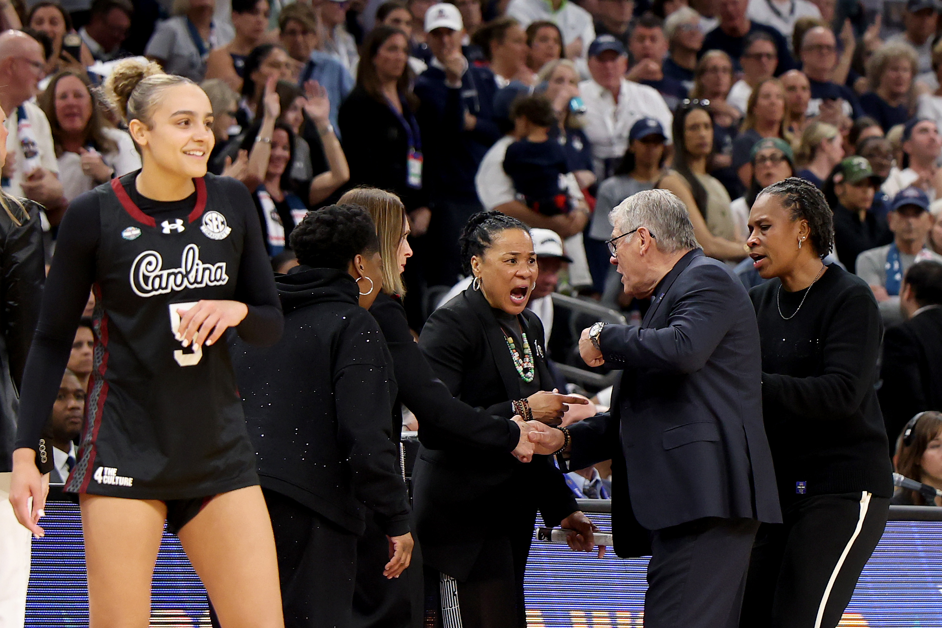 PHOENIX, ARIZONA - APRIL 03: Head coach Dawn Staley of the South Carolina Gamecocks and head coach Geno Auriemma of the UConn Huskies exchange words during the fourth quarter in the Final Four of the NCAA Women's Basketball Tournament at Mortgage Matchup Center on April 03, 2026 in Phoenix, Arizona. (Photo by Christian Petersen/Getty Images)