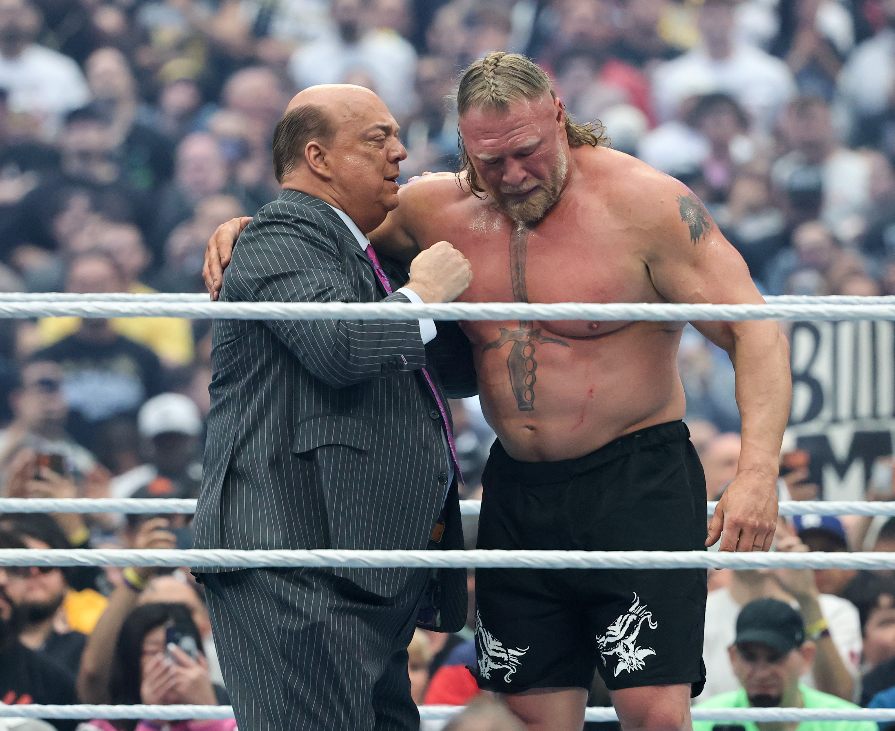 LAS VEGAS, NEVADA - APRIL 19: Paul Heyman (L) consoles Brock Lesnar after he appeared to retire following his loss to Oba Femi in their match during WrestleMania 42 at Allegiant Stadium on April 19, 2026 in Las Vegas, Nevada. (Photo by Ethan Miller/Getty Images)