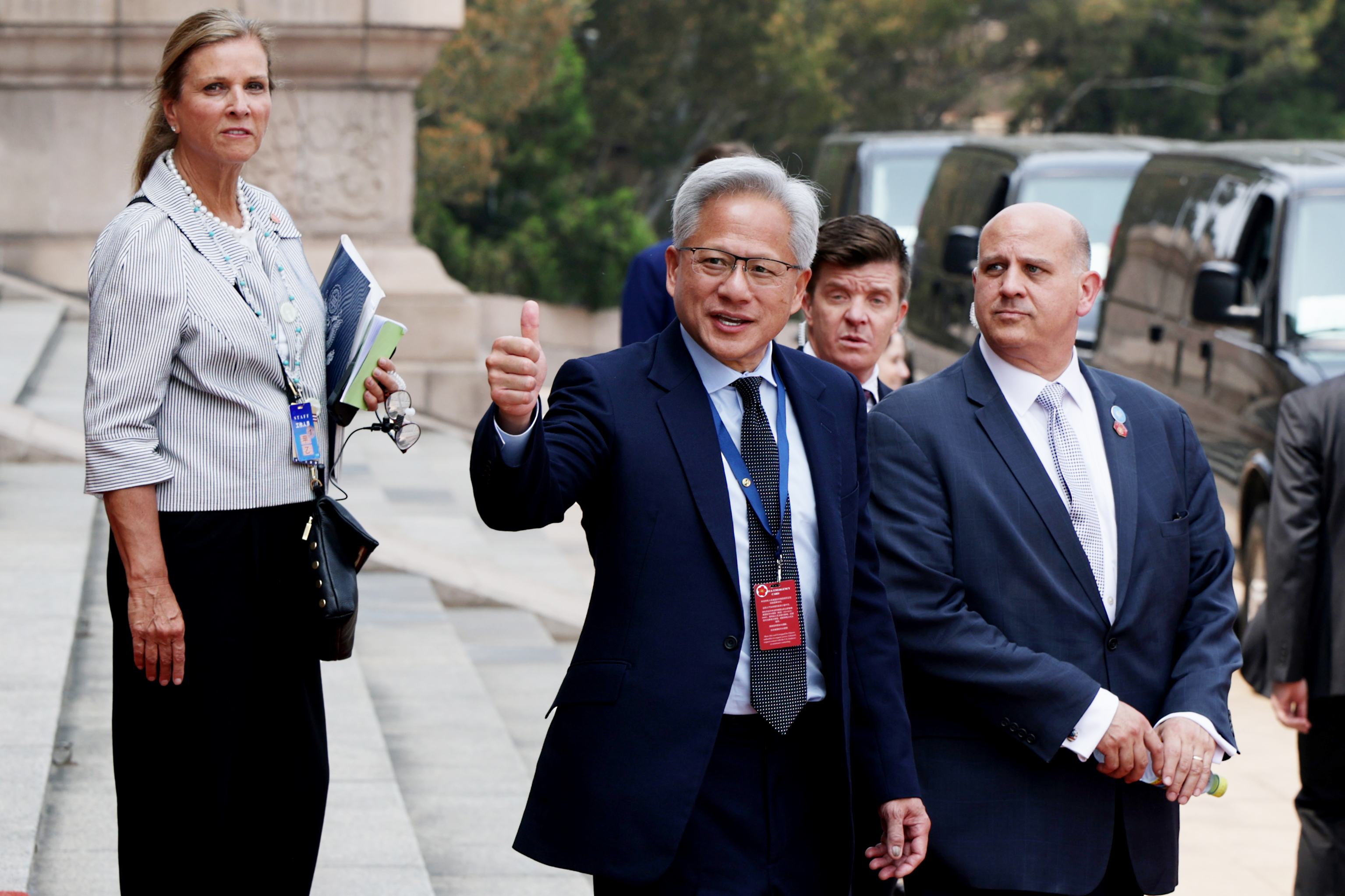 BEIJING, CHINA - MAY 14: Nvidia CEO Jensen Huang (C) gestures as he prepares to depart following a welcome ceremony at the Great Hall of the People on May 14, 2026 in Beijing, China. President Trump is meeting with President Xi Jinping in Beijing to address the Iran conflict, trade imbalances, and the Taiwan situation while establishing new bilateral boards for economic and AI oversight. (Photo by Alex Wong/Getty Images)